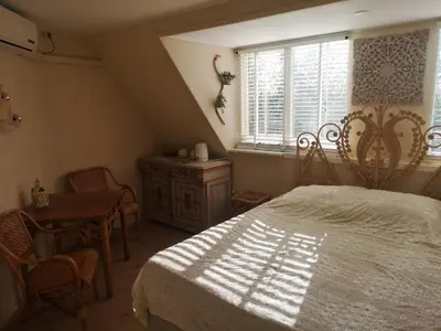 a bedroom with a bed and a table and a window at Modern Cozy Asian Style bedroom with Kingsize Spa bath in Westbeemster