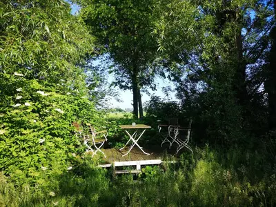 a picnic table and a bench in a park with trees at Modern Cozy Asian Style bedroom with Kingsize Spa bath in Westbeemster