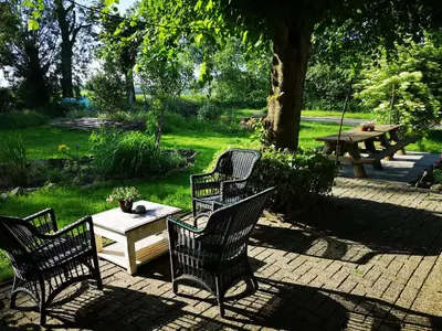 a group of chairs and a table in a yard at Modern Cozy Asian Style bedroom with Kingsize Spa bath in Westbeemster