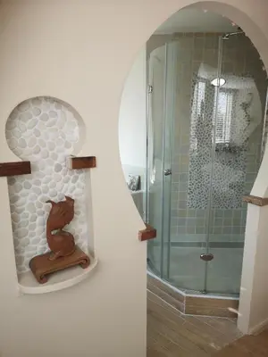 a bathroom with a shower and a figurine of a bear at Modern Cozy Asian Style bedroom with Kingsize Spa bath in Westbeemster