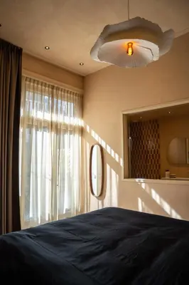 a bedroom with a bed and a large window at Léo Léo in Utrecht