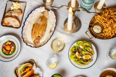 a table topped with plates of food and bowls of food at Léo Léo in Utrecht