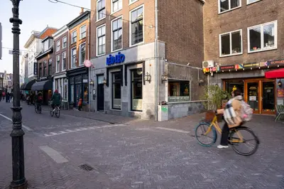 a person riding a bike on a city street at Léo Léo in Utrecht