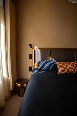 a bedroom with a bed and a table and a window at Léo Léo in Utrecht
