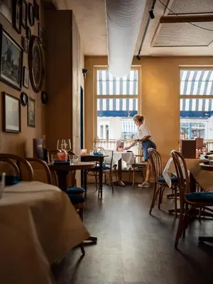 a woman sitting at a table in a restaurant at Léo Léo in Utrecht