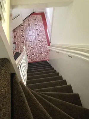 a staircase in a building with brown carpet at B&B House No 7 in Amsterdam