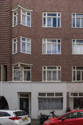 a brick building with cars parked in front of it at B&B House No 7 in Amsterdam