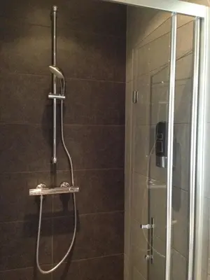 a shower with a glass door in a bathroom at B&B House No 7 in Amsterdam