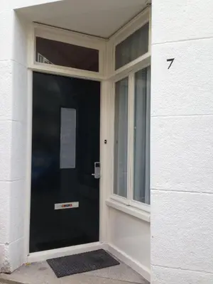 a black door with a window on a building at B&B House No 7 in Amsterdam