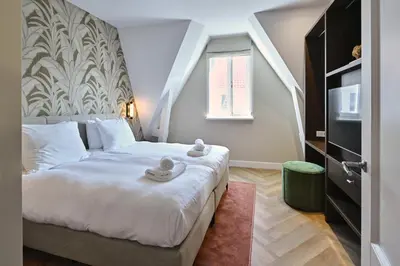 a bedroom with a bed with towels on it at Jorisz Apartments in Haarlem