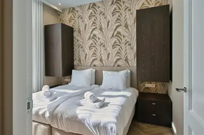 a bedroom with two beds with towels on them at Jorisz Apartments in Haarlem