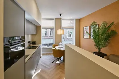 a kitchen with a table and a plant in it at Jorisz Apartments in Haarlem