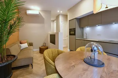 a kitchen and living room with a wooden table and chairs at Jorisz Apartments in Haarlem