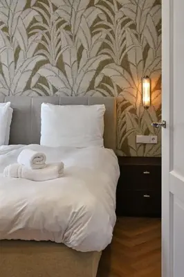 a bedroom with a bed with towels on it at Jorisz Apartments in Haarlem