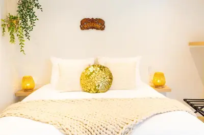 a bed with a gold plate on top of it at Vakantie in Noordwijk in Noordwijk