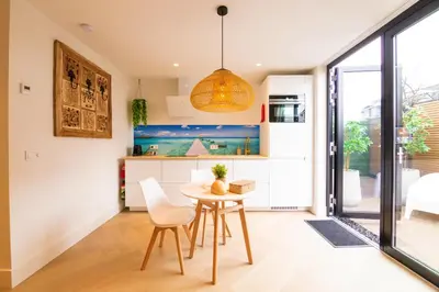 a kitchen and dining room with a table and chairs at Vakantie in Noordwijk in Noordwijk