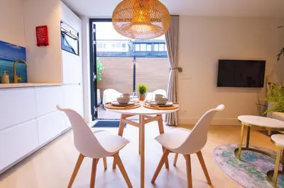 a kitchen and dining room with a table and chairs at Vakantie in Noordwijk in Noordwijk