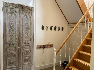 an old wooden door in a hallway with stairs at Villa free standing 25 min Amsterdam 10 min beach in Akersloot