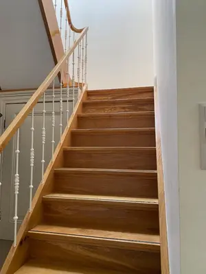 a staircase with wooden stairs and white railings at Villa free standing 25 min Amsterdam 10 min beach in Akersloot
