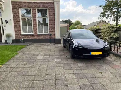 a black car parked in front of a house at Villa free standing 25 min Amsterdam 10 min beach in Akersloot