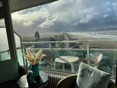 a balcony with a view of the beach and the ocean at Annet's Studio in Zandvoort