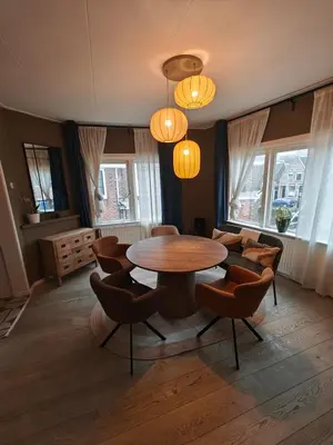 a living room with a table and chairs at Alkmaar canal apartment in Alkmaar