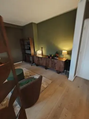 a living room with a couch and a desk at Alkmaar canal apartment in Alkmaar