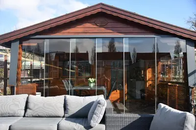a glass house with a couch in front of it at De Narcis in Lisse