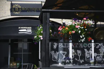 a store front with flowers in a window at De Narcis in Lisse