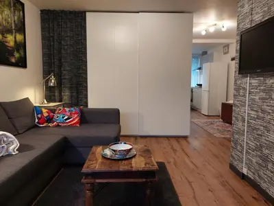 a living room with a couch and a table at Hagerstudio in Huizen