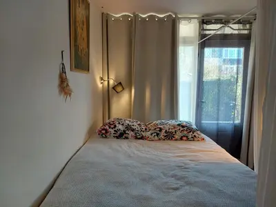 a bed with two pillows in a bedroom with a window at Hagerstudio in Huizen