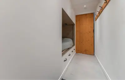 a small bedroom with a bed in the corner at Grandioso Appartement - Studio in Castricum