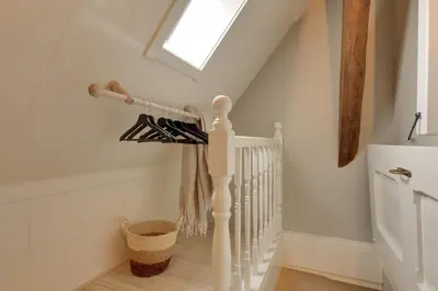 a white staircase with a skylight in a house at Boutique Hoeve de Berg in Uitgeest