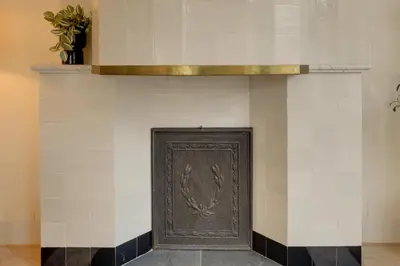 a brown door on a white and black wall at Boutique Hoeve de Berg in Uitgeest