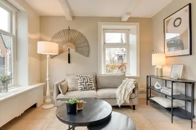 a living room with a couch and a table at Boutique Hoeve de Berg in Uitgeest