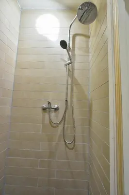 a shower with a shower head in a bathroom at Hotel La Belle Vue in Amsterdam