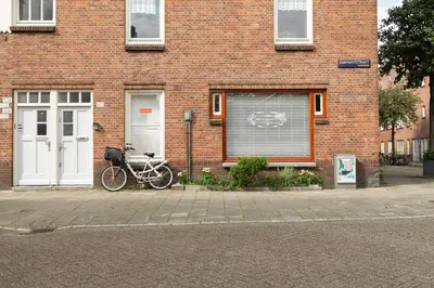 a bike parked in front of a brick building at Zoet Amsterdam in Amsterdam