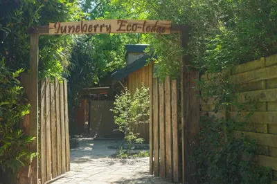 an entrance to a fence with a wooden gate at Juneberry Ecolodge Bergen in Bergen
