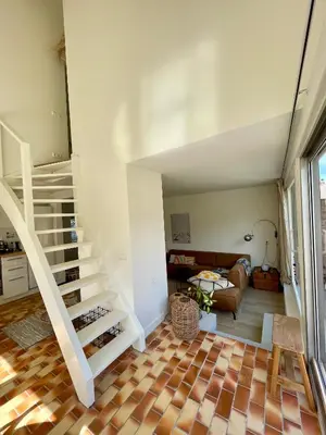 a room with a staircase and a living room at Holiday home close to beach and Keukenhof in Noordwijkerhout