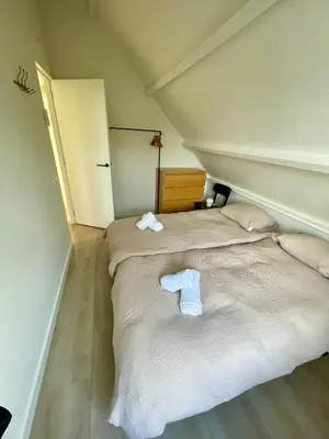 a bedroom with two beds with towels on them at Holiday home close to beach and Keukenhof in Noordwijkerhout