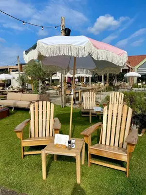 two chairs and a table with an umbrella at Holiday home close to beach and Keukenhof in Noordwijkerhout