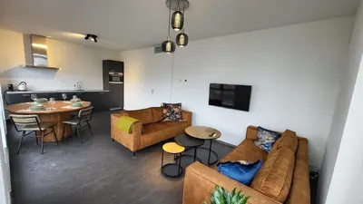 a living room with a couch and a table at B&B Kopwest 1 in Purmerend