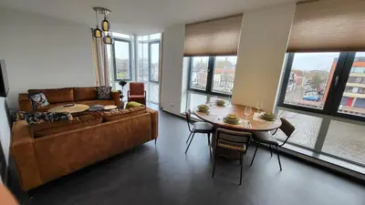 a living room with a couch and a table with chairs at B&B Kopwest 1 in Purmerend