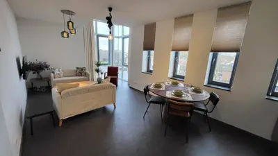 a living room with a table and a couch at B&B Kopwest 2 in Purmerend