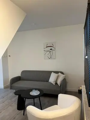 a living room with a couch and a table at Cozy 2 bedroom apartment in Maarssen