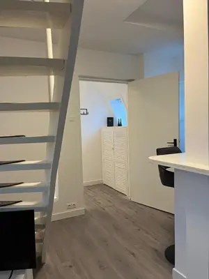 a staircase in a room with a desk and a hallway at Cozy 2 bedroom apartment in Maarssen