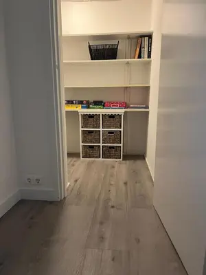 an empty room with a book shelf and wooden floors at Cozy 2 bedroom apartment in Maarssen
