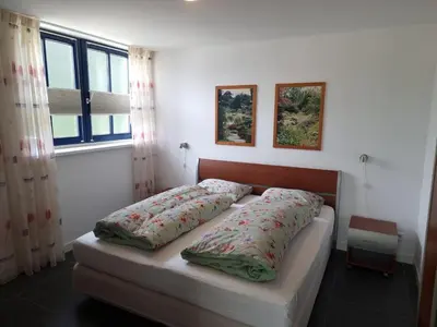 a bed with two pillows on it in a bedroom at De bloemenkwekerij in Egmond-Binnen
