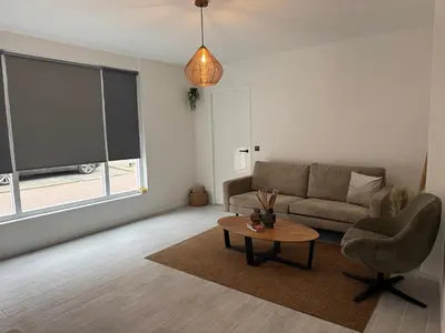 a living room with a couch and a table at Smile home 3 Wormerveer- Zaanse Schans en Amsterdam appartements in Wormerveer