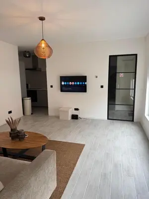 a living room with a couch and a table at Smile home 3 Wormerveer- Zaanse Schans en Amsterdam appartements in Wormerveer